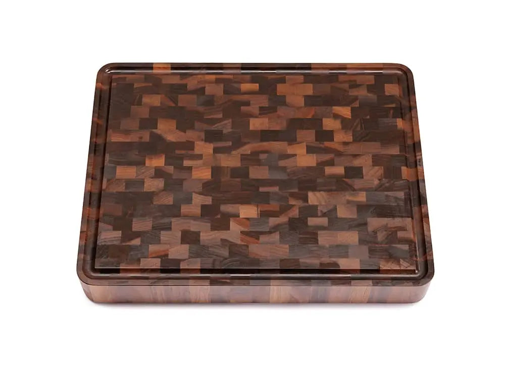 Top view of a rectangular black walnut end grain butcher block with a checkered pattern and a juice groove, against a white background