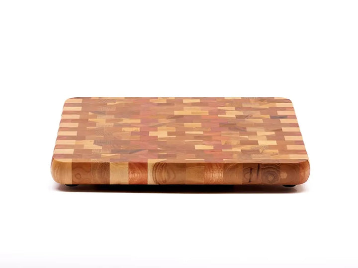 Front view of an end-grain cutting board with a checkered pattern of various wood tones, featuring rounded corners and a smooth finish, against a white background