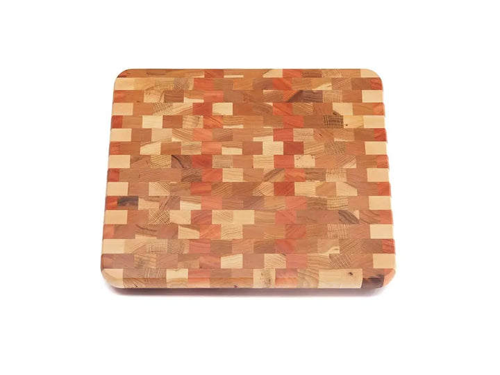 Top view of an end-grain cutting board with a checkered pattern of various wood tones, featuring rounded corners and a smooth finish, against a white background