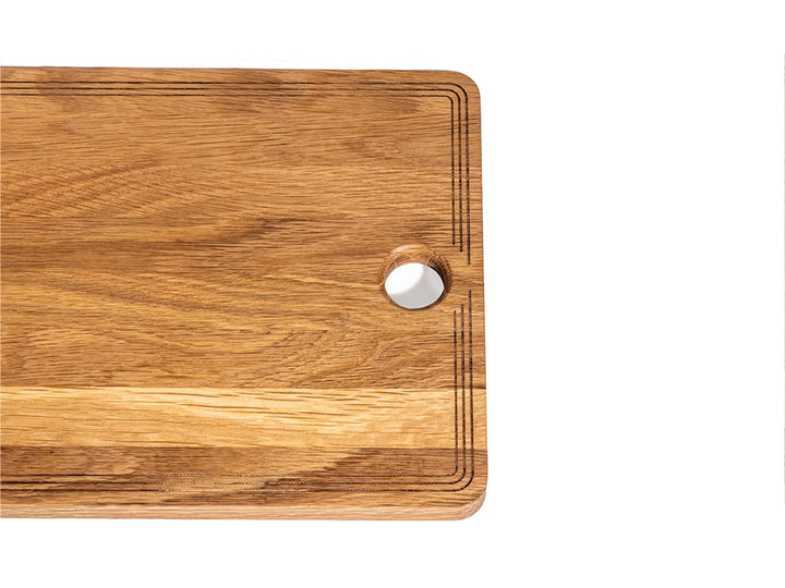 Handcrafted white oak charcuterie board with laser-engraved border and thumb hole for easy handling