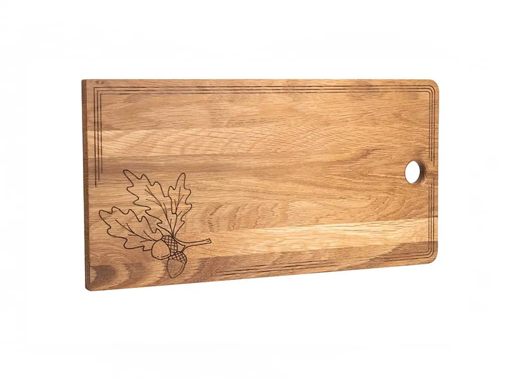 White oak charcuterie board with engraved oak leaves, laser-etched border, and thumb hole for hanging