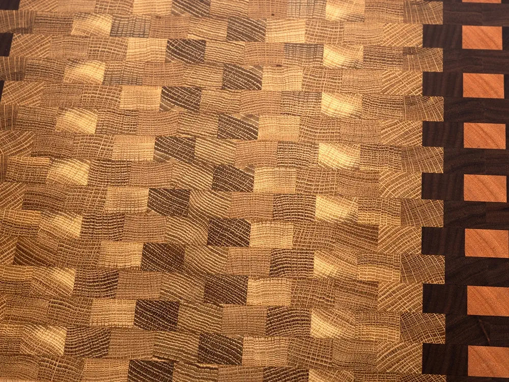 Close-up of end grain cutting board showing natural wood grain texture and diagonal checkerboard pattern