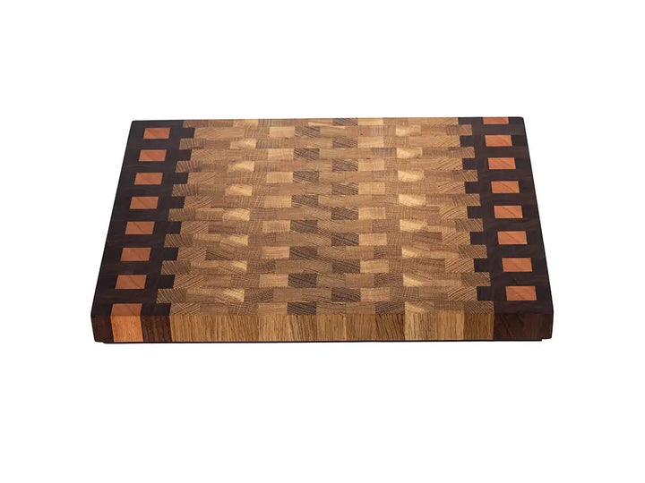 Rectangular end grain cutting board with geometric pattern and decorative borders in mixed hardwoods