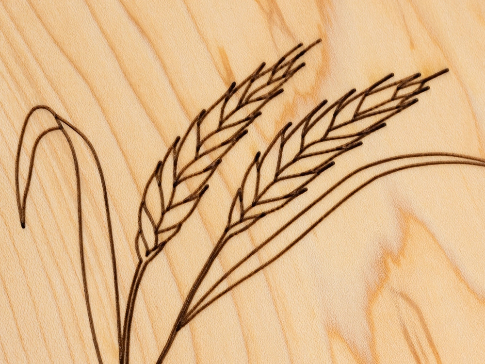 A close-up view of the engraved Wheat design on a Wooden Trivet on a white background.