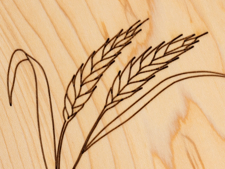 A close-up view of the engraved Wheat design on a Wooden Trivet on a white background.