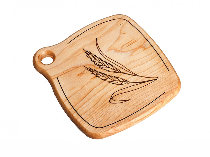 A Wooden Trivet with engraved Wheat design on a white background