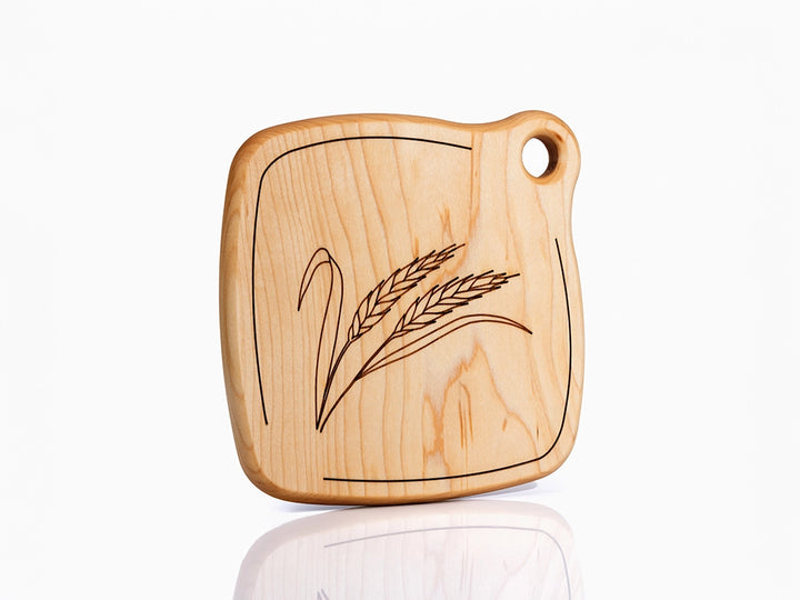 A Wooden Trivet with engraved Wheat design on a white background