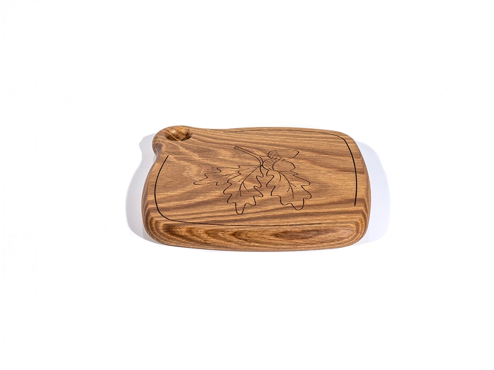 A front angle view of a Wooden Trivet with a Wheat flower design on a white background