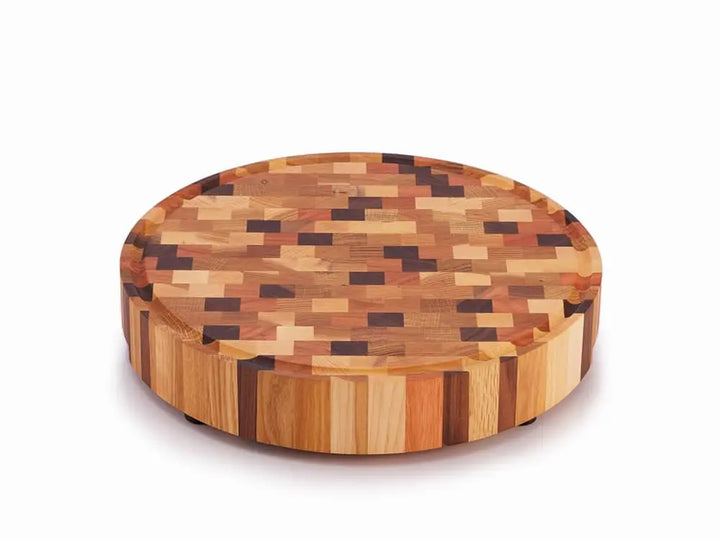 Round end grain butcher block with a multicolored checkered pattern and a juice groove around the edge