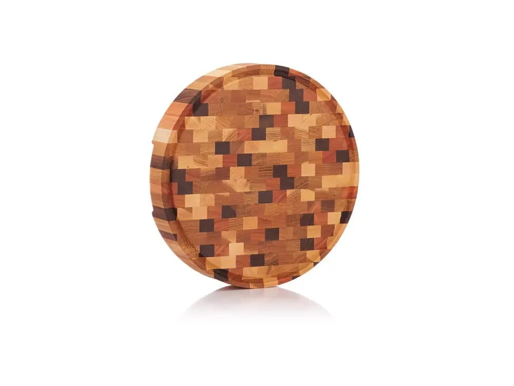 Standing round end grain butcher block with a multicolored checkered pattern and a juice groove, showcasing its vibrant wooden design
